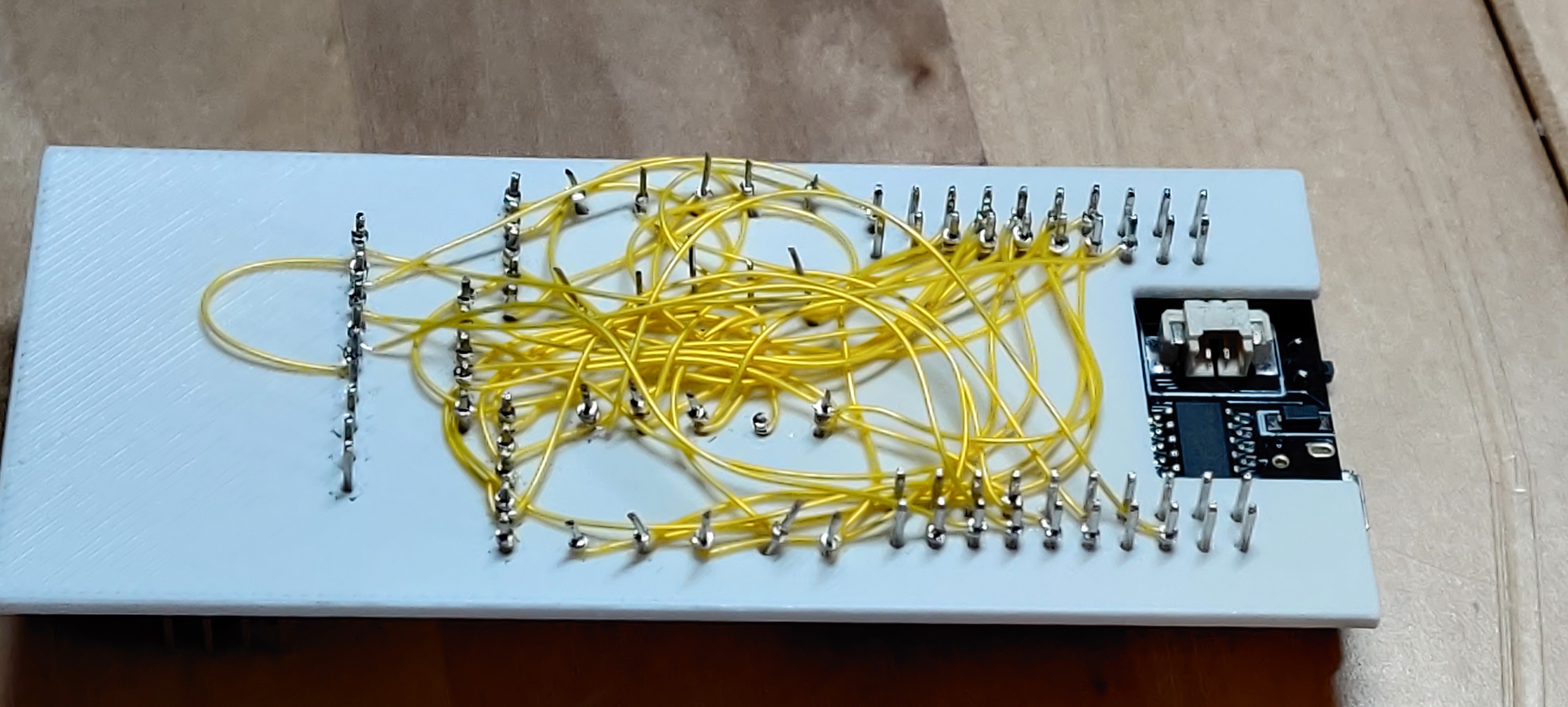 reverse of the populated board, many electrical wires
insulated in yellow plastic connect various pins